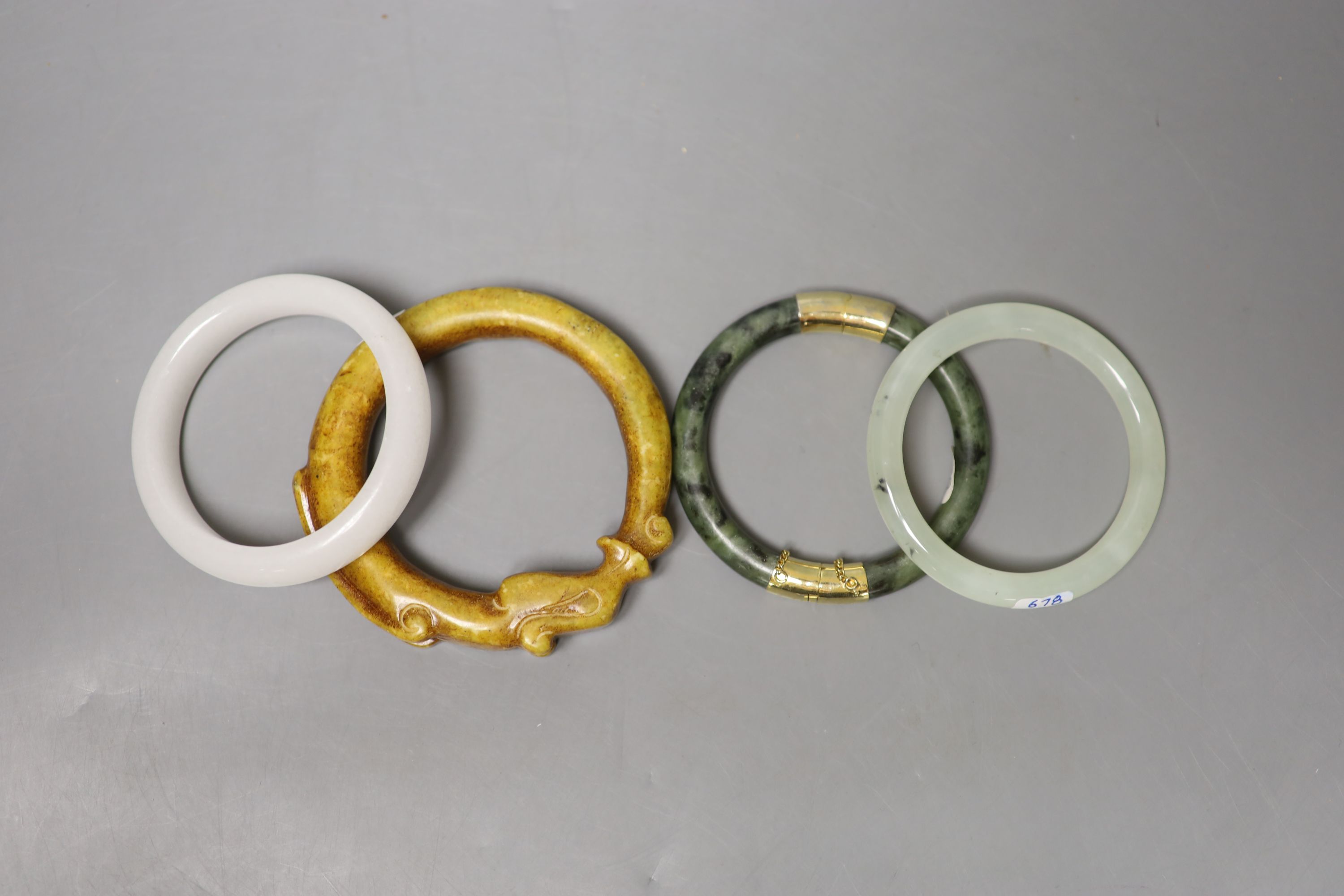 Four Chinese jade or hardstone bangles